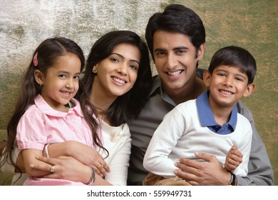 family of four smile at camera