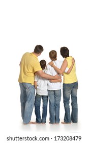 Family Of Four Standing On White Background. Back View