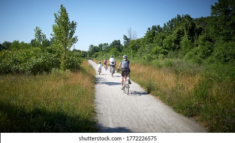 Family Of Four Takes A Bike Ride Through The Malcomson Eco Park In The Niagara Region Of Ontario.  St. Catharines, Ontario. Canada. June 2020