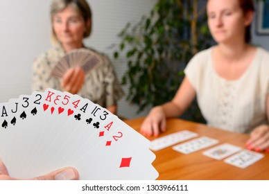 Family Foursome Playing Contract Bridge At Home