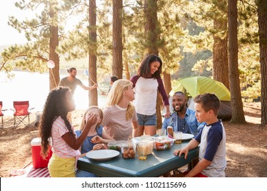 Family With Friends Camp By Lake On Hiking Adventure In Forest - Powered by Shutterstock