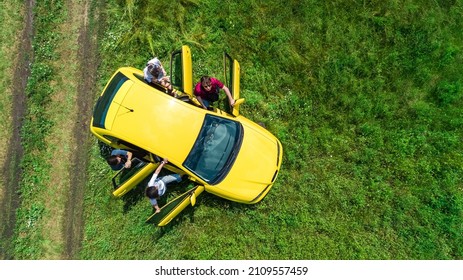 Family and friends car travel on vacation, happy parents and kids have fun in holiday trip, aerial drone view of car and people from above