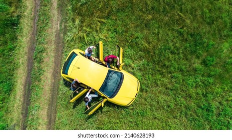 Family and friends car travel on vacation, happy parents and kids have fun in holiday trip, aerial drone view of car and people from above - Shutterstock ID 2140628193