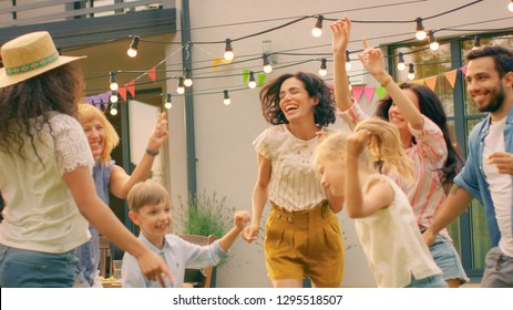 Family and Friends Dancing together at the Garden Party Celebration. Young and Elderly People Having Fun on a Sunny Summer Day Disco.