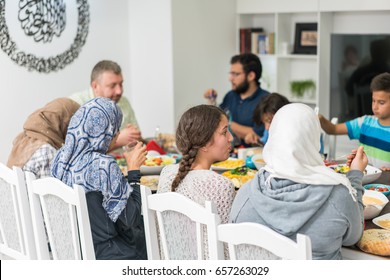 Family and friends gathering together at home for eating dinner