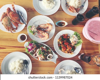 Family Or Friends In Summer Party Or Seafood Set Dinner. Flat-lay Of Group Of Mutinational People At Big Table Eating Delicious Food Together. Summer Gathering Or Celebration. Top View Background.