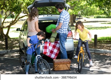 Family in front of a car in the garden