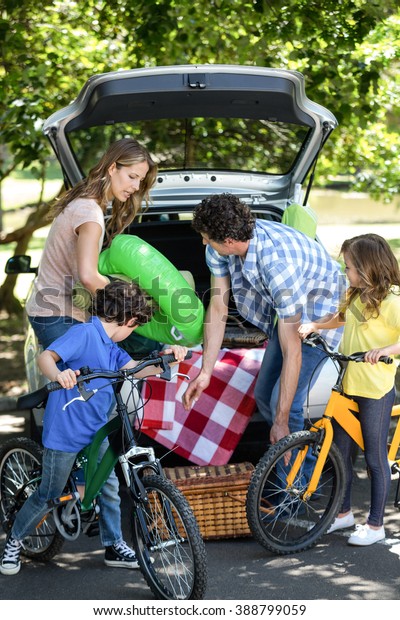 Family in front of a car\
in the garden