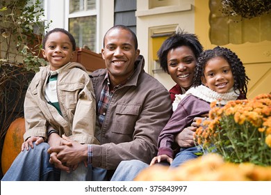 Family In Front Of House