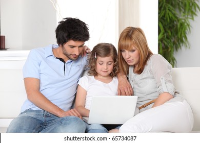 Family In Front Of A Laptop Computer