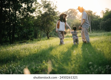 Family Fun in the Great Outdoors: Asian Parents and Cheerful Children Enjoying Summer Camping Vacation, A Happy Day of Leisure and Nature Exploration, Creating Memorable Outdoor Adventures Together - Powered by Shutterstock