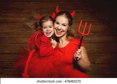 Family fun mother and child daughter having fun and celebrate Halloween in devil costume - Powered by Shutterstock