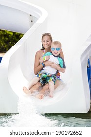 Family Fun On The Water Slide At A Waterpark