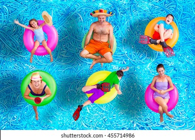 Family fun in the swimming pool in summer with a father, mother, grandmother, boys and a girl floating on colorful inner tubes in their swimsuits in various positions, conceptual image