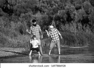 Family Game Of Stone Skipping. Three Generation Family. Father, Son And Grandfather Relaxing Together