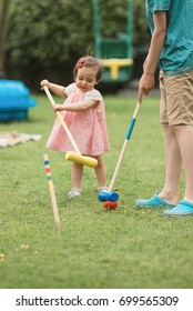 Family Game In A Summer Garden. Kids Playing Croquet Game On A Grass At Back Garden