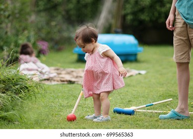 Family Game In A Summer Garden. Kids Playing Croquet Game On A Grass At Back Garden