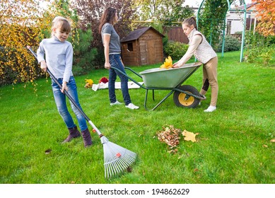 Family Gardening At Backyard In Autumn