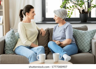 Family, Generation And People Concept - Happy Smiling Senior Mother With Adult Daughter Talking At Home