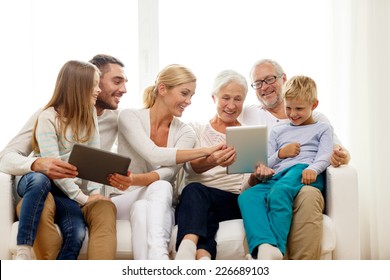 Family, Generation, Technology And People Concept - Smiling Family With Tablet Pc Computers At Home