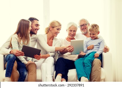 Family, Generation, Technology And People Concept - Smiling Family With Tablet Pc Computers At Home