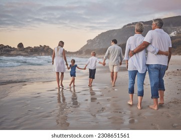 Family, generations and back with walking, beach and sunset with men, women and children with love. Parents, grandparents and kids by ocean, holding hands and bond on summer vacation with solidarity - Powered by Shutterstock