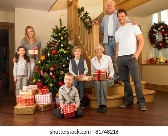 Family With Gifts Around The Christmas Tree