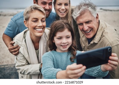 Family, Girl And Phone Selfie On Beach Holiday Adventure Spending Time With Parents And Grandparents. Men, Women And Child Smile In Australia, Happy Fun On Winter Hike By Sea And Photo On Smartphone