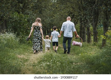 Family Goes On A Picnic In A Green Forest, Spring Mood, A Trip To Nature.