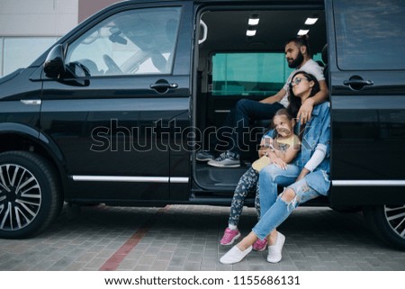 The family goes on a trip with minivan. Happy family sitting in vip van car