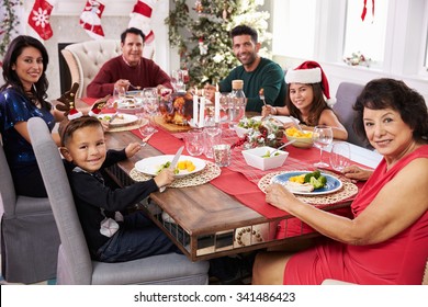 Family With Grandparents Enjoying Christmas Meal At Table