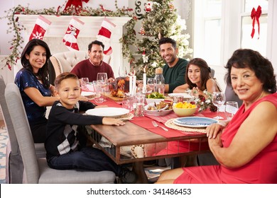 Family With Grandparents Enjoying Christmas Meal At Table