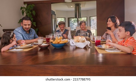 Family With Grandparents Enjoying Thanksgiving Meal At Table. Holidays Or Birthdays.