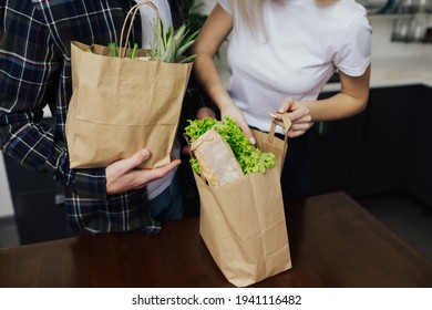 Family Grocery Shopping Online. Couple With Packages Full Of Groceries In Kitchen.