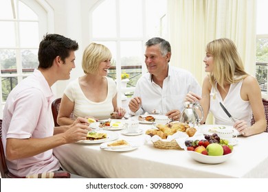 Family Group Enjoying Hotel Breakfast