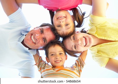 Family Group Looking Down Into Camera