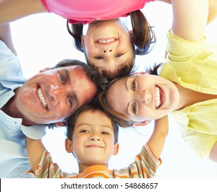 Family Group Looking Down Into Camera