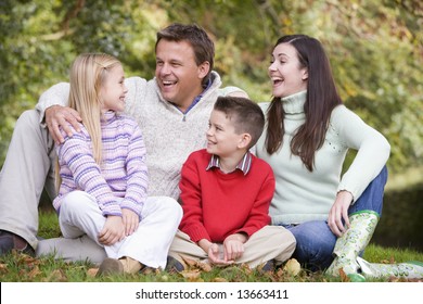 Family Group Relaxing Amongst Autumn Woodlands