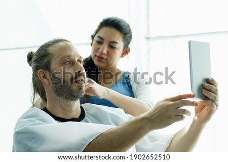 Similar – Female doctor showing results of a medical test on the tablet