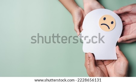 Family hands holding sad face in brain paper cut, feeling mood unhappy hormones, imbalance brain chemicals, negative mental health care concept [[stock_photo]] © 