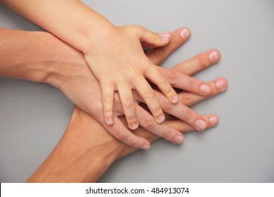 Family Hands On Gray Background