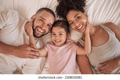 Family Happy, Child And Above Bed With Parents In The Morning, Funny Face In House And Relax After Sleeping Together In Home. Portrait Of Happy Mother And Dad Smile With Girl Kids In Home Bedroom