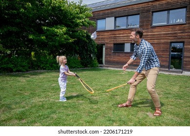 Family Happy Moments In Backyard Father And Daughter Play Badminton