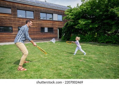 Family Happy Moments In Backyard Father And Daughter Play Badminton