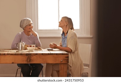 Family, happy woman and senior mother drinking coffee at breakfast, bonding and smile. Elderly mom, adult and tea cup at table for conversation, love and daughter eating cookies at home together - Powered by Shutterstock