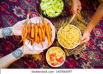 Family Have, Eat Meal Together. Adult And Child, Kid Hands. Rich Vegetarian, Vegan Lunch Or Dinner With Baked Carrots, Vegetables Salad And Cooked Bulgur Grain In Bowls. 