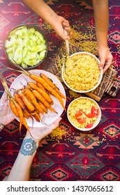 Family Have, Eat Meal Together. Adult And Child, Kid Hands. Rich Vegetarian, Vegan Lunch Or Dinner With Baked Carrots, Vegetables Salad And Cooked Bulgur Grain In Bowls. 