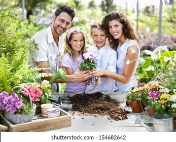 Family Have Fun In The Work Of Gardening