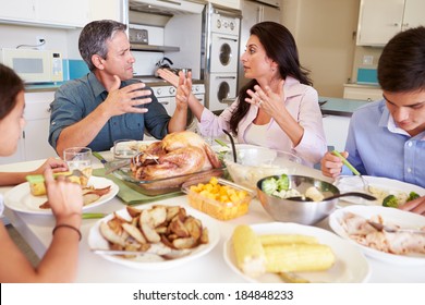 Family Having Argument Sitting Around Table Eating Meal