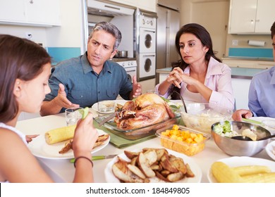 Family Having Argument Sitting Around Table Eating Meal